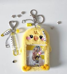 a cell phone case with an emo chick on the front and keychain attached to it