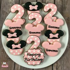 mickey mouse and minnie mouse birthday cookies on a white plate with the number twenty two