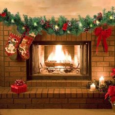 a fireplace decorated for christmas with stockings and candles