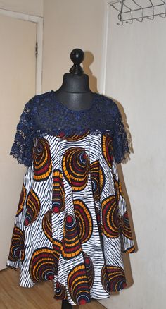 This is a  vibrant handmade short flared dress with lace detail. This dress has pockets - stylish and practical, perfect for all  occasions.  Currently available in two sizes. Size: UK10 Size: 14 - 16UK Feel free to send me a message if you have any questions. Flared Lace Dress Styles, Ankara Flared Dress Styles, Short Flare Dress Ankara, Short Dresses Ankara Styles, Ankara Free Gown Styles For Women Short, Lace Short Dress Styles, Ankara Free Short Gown Styles, Ankara Flare Dresses Short, Free Gown Styles For Women