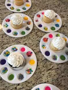 cupcakes and sprinkles are on white plates