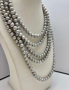 Material : Genuine Freshwater Pearl Length : 90 inch ready to wear necklaces Shape : Potato with Ring Bead Size: 7-8 mm Color : 2 Color Options :- - Natural White - Silver Gray Shipping : We ship all orders within 24 hours from the U.S. (We closed on Saturday and Sunday) ** We Offer CUSTOM MADE SERVICES and WHOLESALE DISCOUNTS on LARGE QUANTITY PURCHASE. Please convo us on your requirements. We will be happy to create a private listing for you** As the variations in materials, there might be sli Silver Bridal Necklace With Polished Round Beads, Silver Bridal Necklace With Round Beads, Gray Round Pearl Jewelry, Silver Necklace With Round Beads For Wedding, Gray Round Necklace For Formal Occasions, Elegant Gray Necklace For Wedding, Gray Single Strand Jewelry With Round Beads, Gray Single Strand Round Bead Jewelry, Silver Pearl Necklace With Round Beads For Wedding