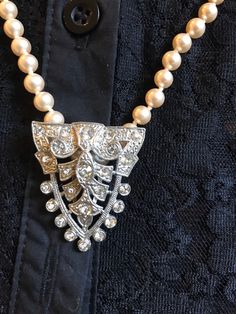 "I love this combination so I decided to sell them together. Beautiful strand of faux hand knotted pearls stamped Japan and 24\" Long. I have added the stunning Vintage Dress Clip with beautiful clear bezel set rhinestones in a shield shape. Very flattering to the neck. You can wear the pearls Alone or with the clip. You can wear the clip on a collar, a dress, Jacket, in your hair or on a purse. The pearls are a beautiful soft Creamy shade with an  Almost rose hint to them." Vintage Dress Clips, Elegant Embellished Crystal Rhinestone Necklace, Elegant Crystal Embellished Rhinestone Necklace, Vintage Pearl Necklaces With Rhinestones, Elegant Rhinestone Necklace For Vintage Events, Elegant Pearl Necklace With Rhinestones For Formal Occasions, Elegant Formal Pearl Necklace With Rhinestones, Elegant Pearl Necklace With Crystal Rhinestones, Formal Beaded Pearl Rhinestone Necklace