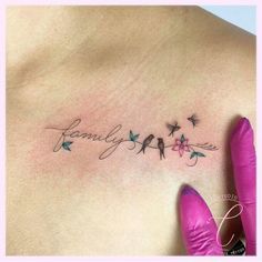 a woman's chest with birds and flowers on it, the word family written in cursive writing