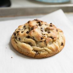 a chocolate chip cookie sitting on top of a white napkin