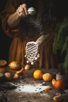 someone is sprinkling salt on an orange