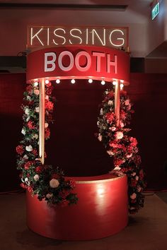 a red booth with flowers and lights on it