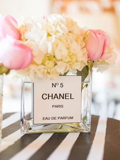 a table topped with vases filled with white and pink flowers