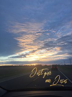 the sun is setting over an empty road with writing on it that says, don't give me jesus