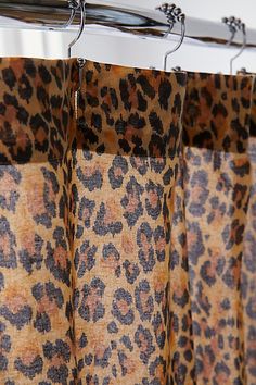 leopard print curtains hanging on a metal rod