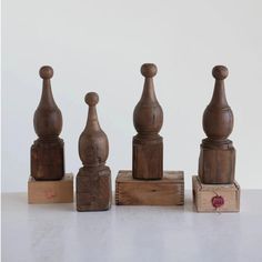 three wooden chess pieces sitting next to each other