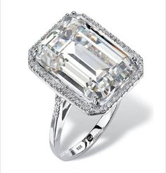 an emerald - cut diamond ring with diamonds surrounding it