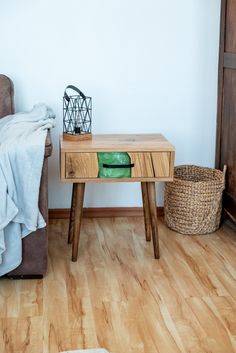 a small wooden table sitting on top of a hard wood floor next to a chair