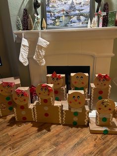 a group of gingerbread men sitting in front of a fireplace