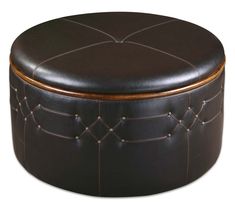 a brown leather ottoman sitting on top of a white floor