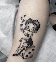 a woman sitting on top of a dice tattoo