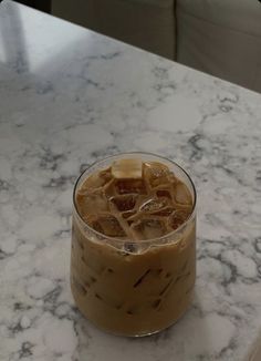 an iced drink sitting on top of a marble table