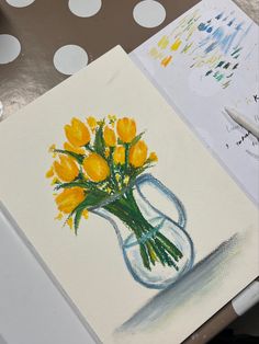 a painting of yellow flowers in a glass vase on a table with polka dot paper