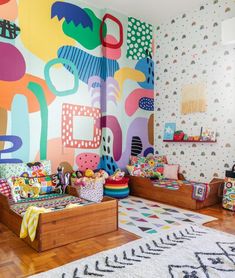 a brightly colored room with wooden flooring and colorful wallpapers on the walls