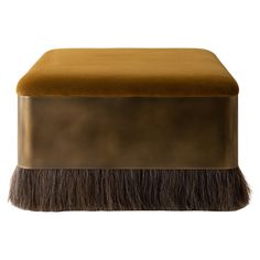 the footstool is made out of gold and brown velvet