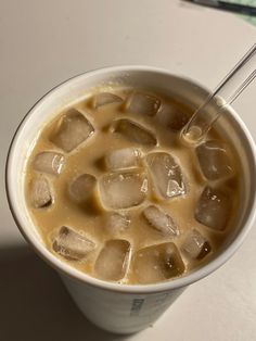 a cup filled with ice sitting on top of a table