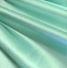 a close up view of the fabric in light blue green color, it is very soft and shiny