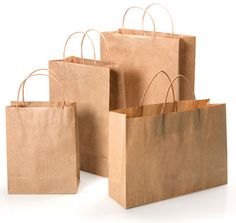 three brown paper bags sitting next to each other