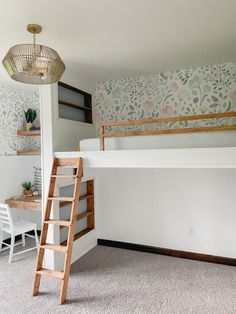 a bedroom with a loft bed, desk and ladder