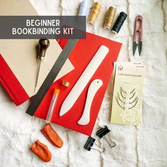 the beginner bookbining kit is laid out on a bed