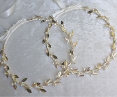 two white headbands with gold leaves and pearls