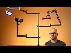 a man sitting in front of a camera and some lights