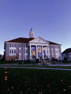 a large building with a clock tower on the side of it's front entrance