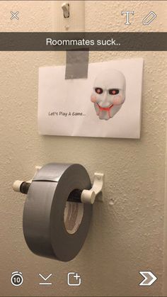 a toilet paper dispenser on the wall next to a roll of toilet paper