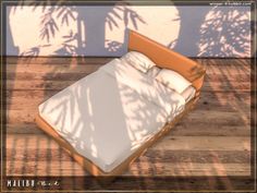 a bed sitting on top of a wooden floor next to a wall with palm trees