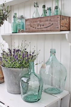 some glass bottles are sitting on a shelf