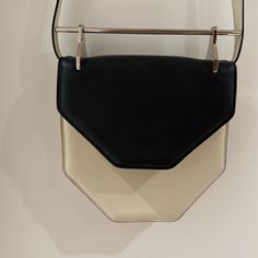 Rare Black And Ivory M2malletier Leather Handbag With Metal Handle Makes For The Coolest Evening Bag In Its Hexagonal Shape. Magnetic Clasp And Pockets Inside. In Pristine Condition Designer White Flap Bag For Evening, Designer White Flap Bag For Formal Occasions, Chic Cream Flap Bag For Formal Occasions, Cream Rectangular Flap Bag For Evening, Cream Top Handle Box Bag For Evening, Modern White Satchel Flap Bag, White Top Handle Flap Bag For Evening, Modern Cream Box Bag With Detachable Handle, Modern Cream Satchel For Formal Occasions