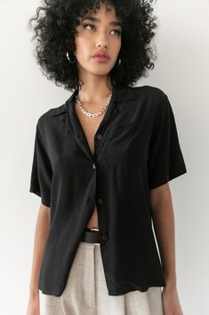 Named after the elegant Carmen Kass, comes the Kass top. This timeless silk button down is the perfect go to piece for your wardrobe. With an oversized fit, it the perfect mix of masculinity and femininity. Black - 100% Silk Crepe Dry Clean Only. Saiai is 5'8 / 172 cm and wearing a size 1 which is equivalent to a Small. Chic Everyday Blouse With Collared Neckline, Black Silk Tops For Daywear, Black Rayon Blouse For Workwear, Chic Rayon Blouse With Buttons, Casual Silk Blouse With Buttons, Daywear Button-up Rayon Shirt, Formal Summer Camp Collar Tops, Oversized Silk Tops, Chic Oversized Silk Top