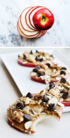 apple halves with chocolate chips and nuts on them sitting on a white plate, ready to be eaten