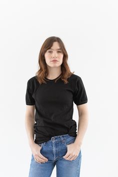 "The softest cotton crewneck tee shirt with banded neck and sleeves. The sleeves are slightly puffy. Contrast Stitching. She is wearing this scrunched up but this is a longer tee.  Material: 100% Cotton  |  Made in Italy | Garment Dyed in L.A. in 2022. Condition: Excellent.  SMALL: Shoulders: 17\"  |  Chest: 15.5\"  |  Length: 26\"  |  Sleeve: 7.5\" Cassie is 5'8\" and wears a Small in modern tops. SHOP http://www.rawsonstudio.etsy.com FOLLOW US + instagram | @_rawson  + pinterest | rawson **No Small Shoulders, Modern Tops, Long Tee, White Crew Neck, Black Vintage, Etsy Fashion, Vintage Cotton, Contrast Stitch, Crew Neck Tee