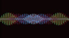 an audio wave on a black background with the colors of blue, green and red