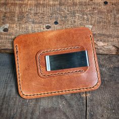 The "Riley" wallet is a must-have for anyone who wants to keep their things organized. It's made from world-famous Horween leather which makes it strong and good-looking. The leather will change color over time and look even better.On the front of the wallet, there are two pockets to put your cards in and a little pocket on top for extra cards. You can put your ID, credit cards, and business cards in these pockets. And the pockets can hold more cards as you use the wallet more.The money clip on Brown Rfid Blocking Wallet For Personal Use, Rectangular Rfid Blocking Wallets For Everyday Use, Modern Rectangular Wallet For Everyday Carry, Leather Wallet With Rfid Blocking, Classic Leather Coin Purse With Card Slots, Leather Trifold Coin Purse With Rfid Blocking, Leather Card Holder With Coin Pocket For Everyday Use, Leather Patch Rectangular Wallet For Daily Use, Leather Wallets With Card Slots For Everyday Use