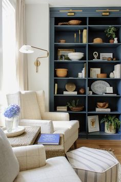 a living room filled with furniture and bookshelves