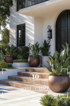 two large planters sitting on the side of a building next to some steps and plants