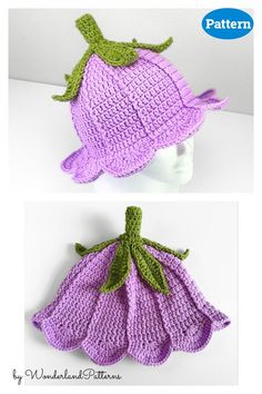 two crocheted hats with green leaves on the top and bottom, one in purple