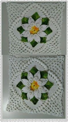 two crocheted squares with white flowers and green leaves on them, one has yellow center