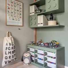 a playroom with legos on the shelves and toys in bins next to it