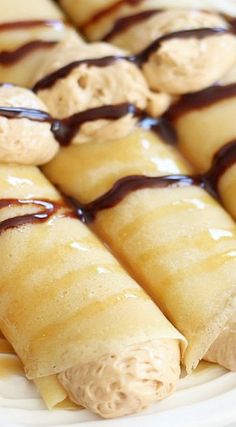 there are many crepes with peanut butter and chocolate drizzled on them