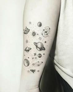 a woman's arm with planets and stars on it