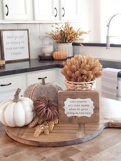 the kitchen counter is decorated with pumpkins and gourds for fall decorating