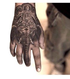 an elephant tattoo on the hand of a man